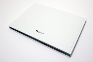 Bird's eye view of back cover of "Surveillance" book laying on white surface